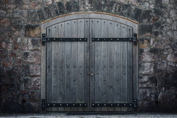 istock Old arched wooden door and stone facade 1524571733