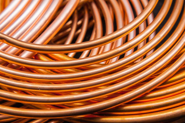 istock Twisted new copper tubes on a black background. 1524663333