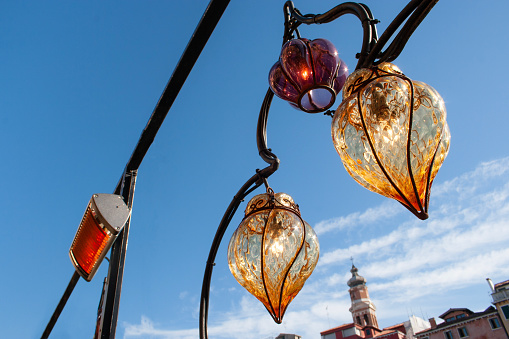 Middle Eastern lambas of different colors and sizes are hanging in the bazaar. Bright traditional Arabic and Turkish lanterns made of metal and glass, inlaid with mosaic details of different colors.