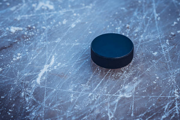 istock hockey puck lies on the snow macro 1524729006
