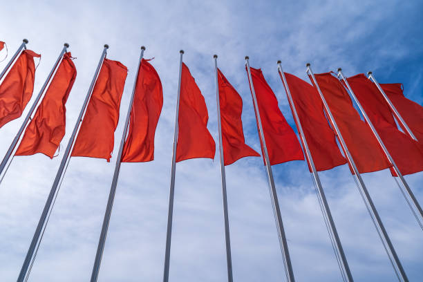 istock a lot many red flags. Red flags in the blue sky with white clouds. 1524757399