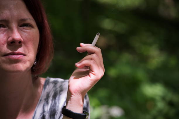 istock Red hair woman smoking cigarette 1524814327