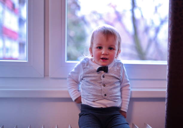istock Little boy sitting on a radiator 1524814853