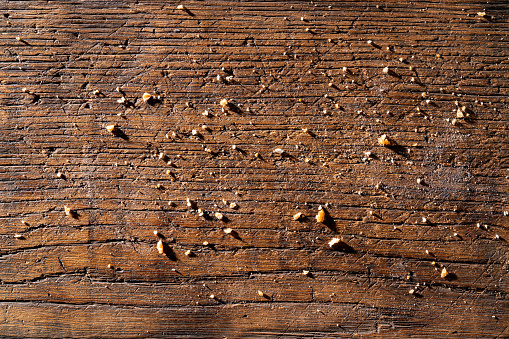 Bread crumbs breadcrumbs texture on a oak rustic wood cutting board background
