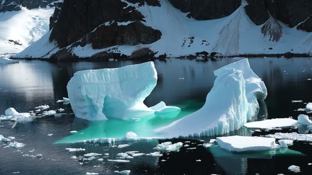 Nature of Antarctica. Icebergs against the background of mountains. Climate Change and Global Warming - Icebergs from melting glacier. Arctic nature ice landscape in Unesco World Heritage Site.