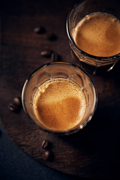 istock Two glasses of espresso coffee on dark rustic background. Copy space 1524874609