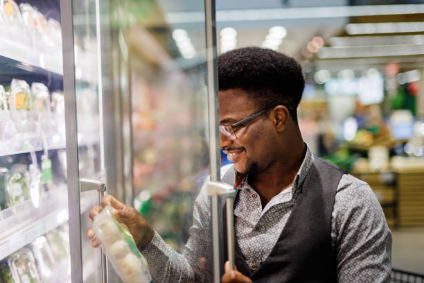 istock Young man reading labels on groceries 1524883466