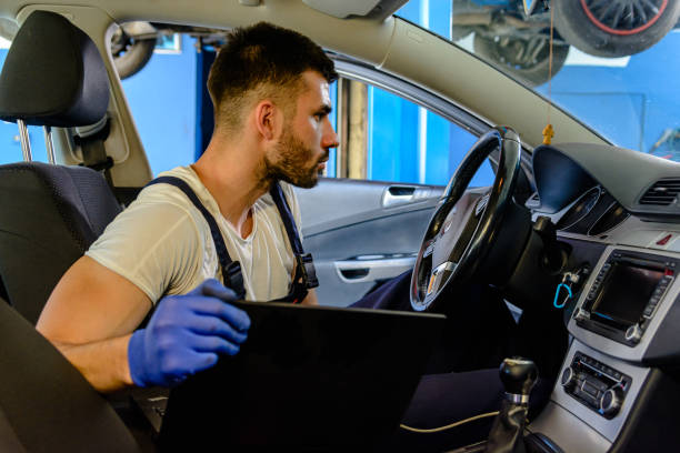 istock A Young Auto Mechanic is Fixing Car Problems with the Online Help from Laptop. 1524912478
