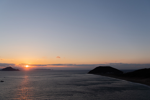 After sunset, view from idyllic village Firostefani on Santorini island, Greece. Sun went down behind Thirasia island. Oia village is on the right side.