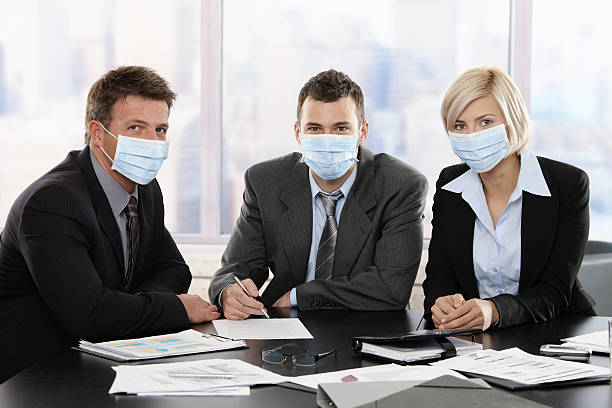 Business people fearing swineflu virus stock photo