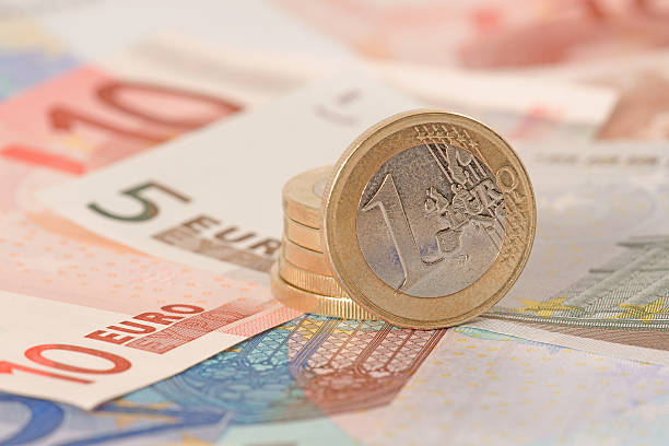 istock Pile of euro coins on banknotes 152494198