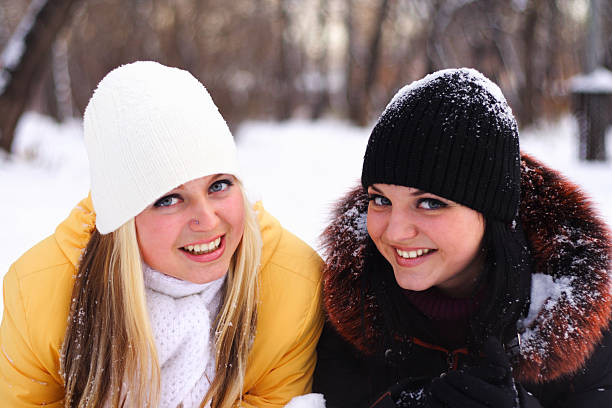 three girls sittin on the frozen river