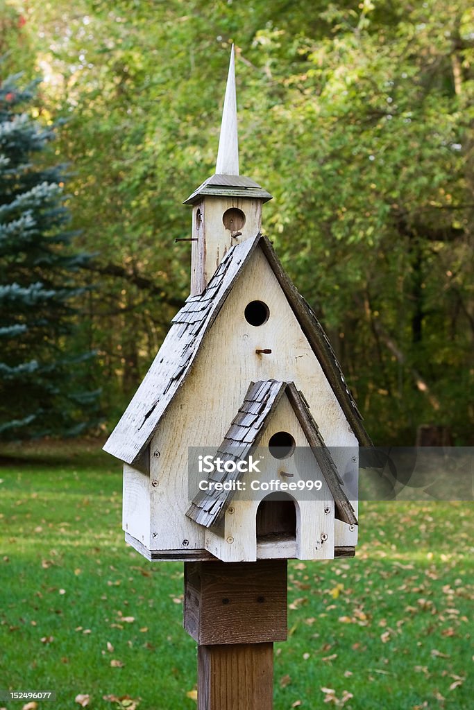 Bird House Home made wooden bird house on a pole. Birdhouse Stock Photo