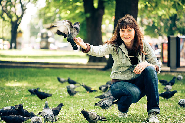 istock Girl with doves in park 152496525