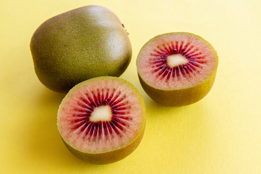 RubyRed Kiwi fruit on a yellow background. Healthy food concept