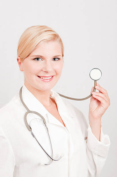 Young professional female doctor with stethoscope stock photo