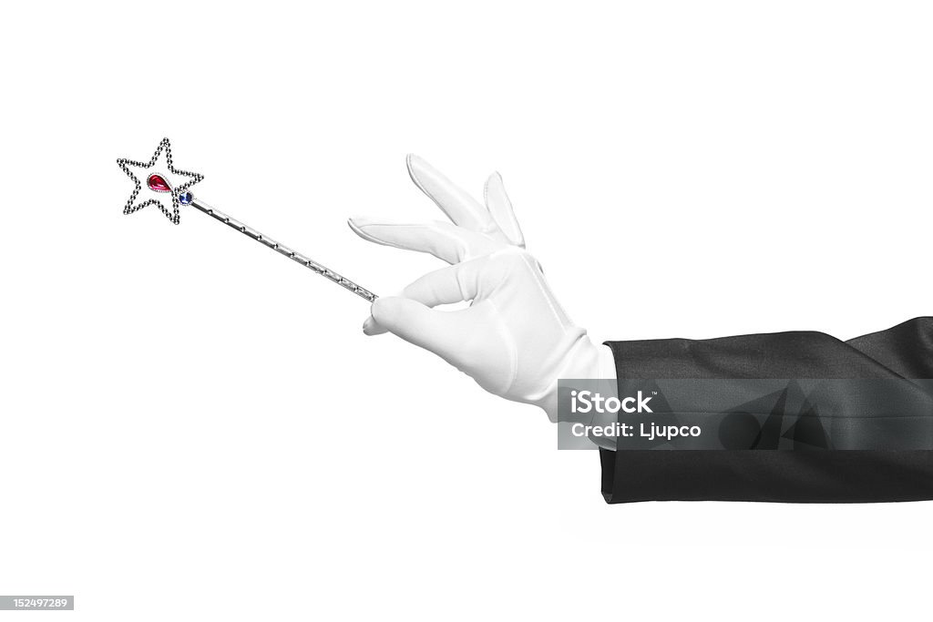 Holding a magic wand Holding a magic wand isolated on white background Magic Wand Stock Photo