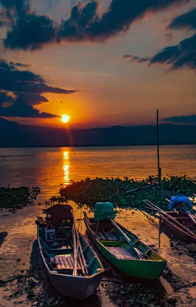 Lake Rawapening, Central Java, Indonesia has a very beautiful afternoon view. Standing in the fishing boat parking lot, we can enjoy the sunset and mountain background.
