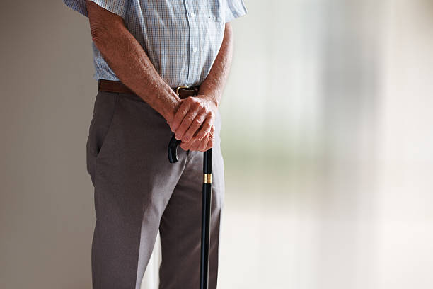 istock Mid section of senior man with walking stick 152498592