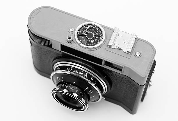 black and white photo of old antique analog photo camera isolated on white