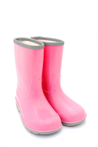 A pair of pink kids gum boots for rainy weather isolated on white studio background