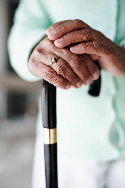 istock Close-up of senior woman's hands on walking stick 152499812