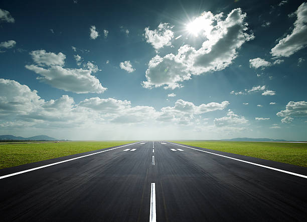 airport runway on a sunny day airport runway under the sun as background runway stock pictures, royalty-free photos & images