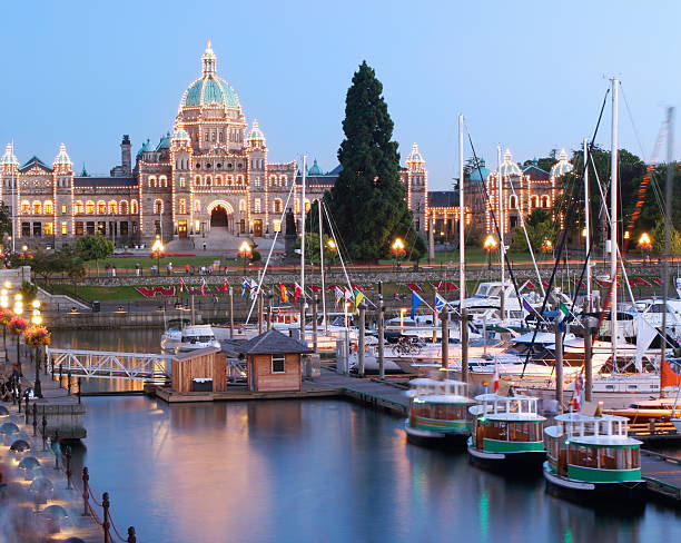 Victoria at Dusk, British Columbia Inner Harbor and Parliament Building of British Columbia at dusk watertaxi stock pictures, royalty-free photos & images