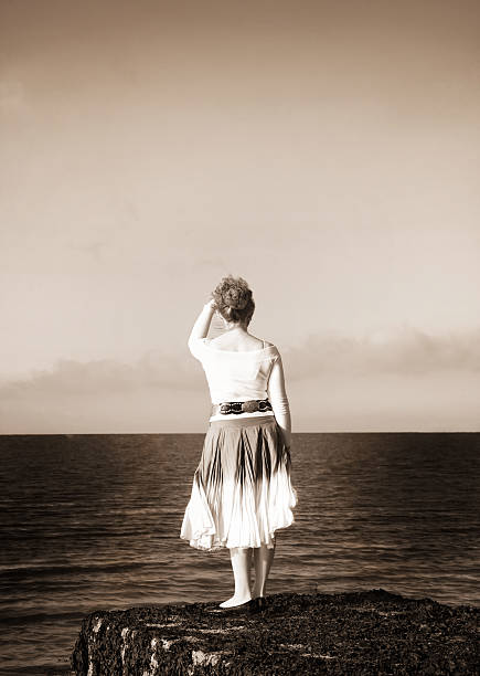 Woman looking at the sea stock photo
