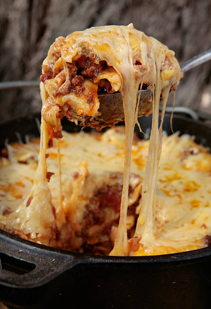A serving of lasagna is scooped from the dish