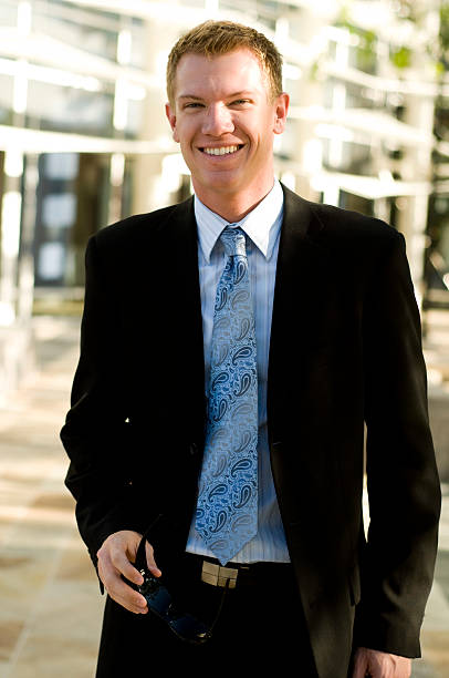 istock Smiling business man in black suit 152503676