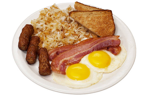 Breakfast Breakfast plate with eggs sunny side up, bacon slices, link sausage, hash browns, and toast.  Isolated on white background with clipping path. breakfast stock pictures, royalty-free photos & images