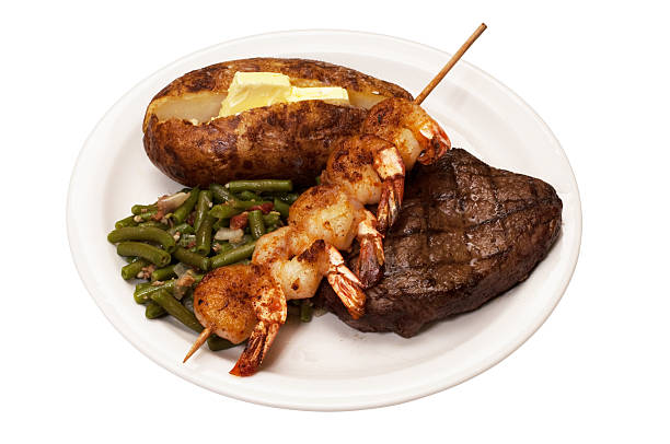 surf and turf - surf and turf prepared shrimp steak grilled fotografías e imágenes de stock