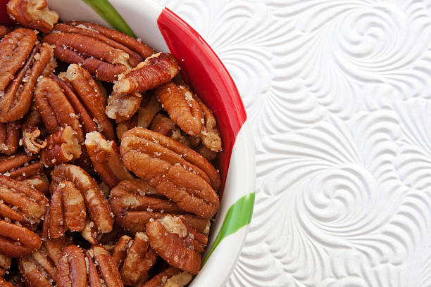 istock Bowl of Roasted Pecans against White Background 152503784