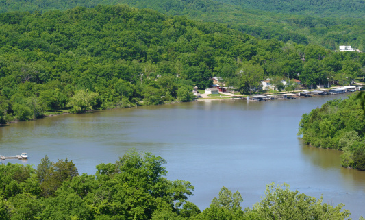 A great view of the lake of the ozarks showing some boat docks and the forrest