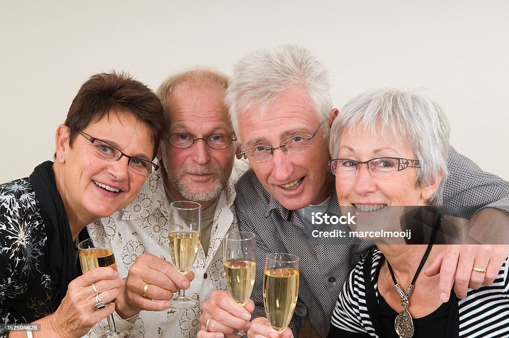 Happy New Year Two senior couples toasting on a Happy New Year. New Year's Eve Stock Photo
