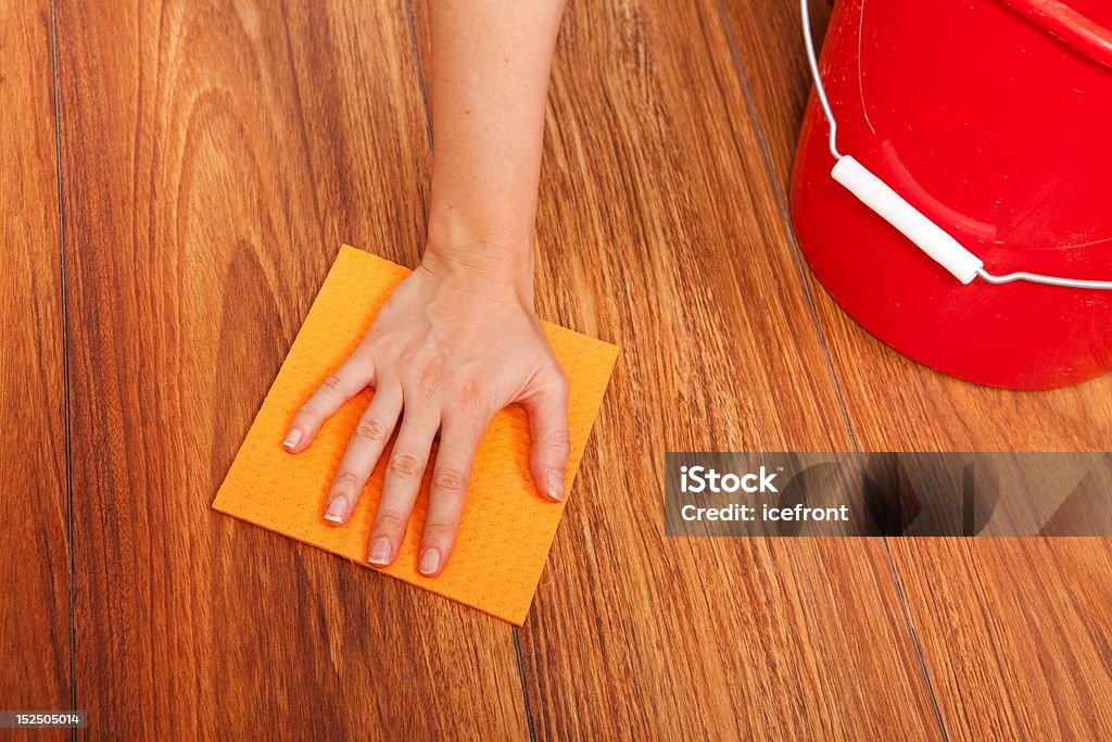 Floor cleaning Woman's hand cleaning the floor with yellow sponge Bucket Stock Photo