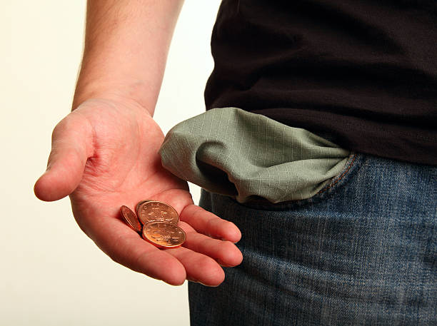 Pocket Money Left Man with an empty pocket and a hand full of change. Focus on Coins. empty pockets stock pictures, royalty-free photos & images