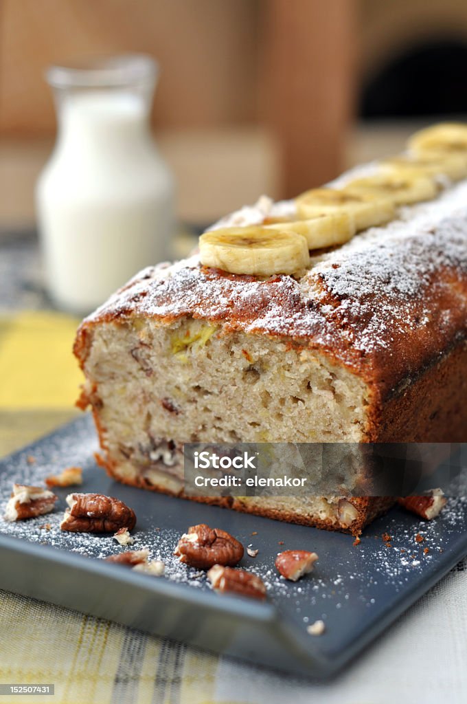 Long loaf of banana bread presented artistically with pecans Banana loaf with walnuts  Banana Bread Stock Photo