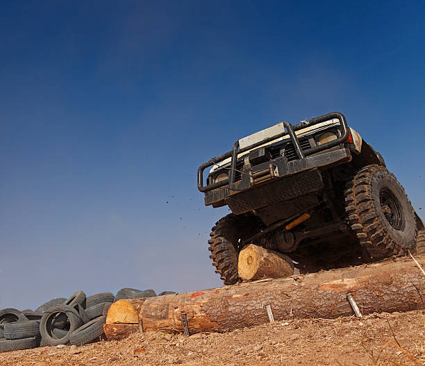 istock Off road track driving over a log 152509275