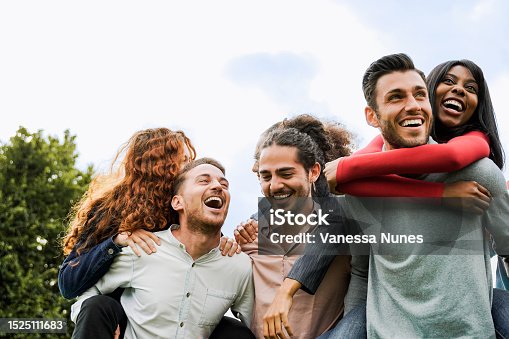 istock Group of young happy people having fun together outside in summer day - Focus on right african girl face 1525111683