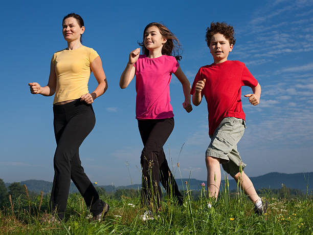 istock Active family running on green meadow 152513256