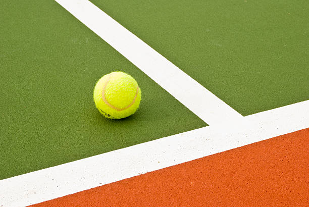 tennis ball in court stock photo