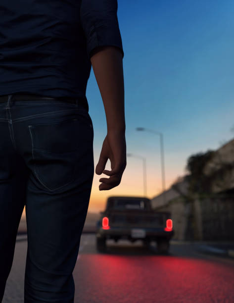 istock Man stands on road with a pickup truck with illuminated tail lights during twilight. 3D render. 1525143770