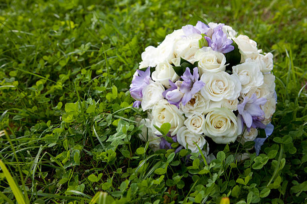 White wedding bouquet on the grass stock photo