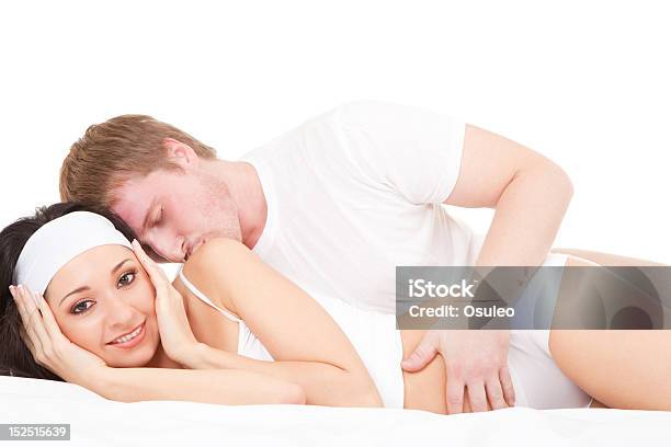 Młoda Szczęśliwa Para Leżąc Na Łóżku Biały - zdjęcia stockowe i więcej obrazów Biały - Biały, Całować, Ciało ludzkie