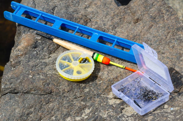 istock Fishing tackle on a stone near the Dnieper River. 1525176752