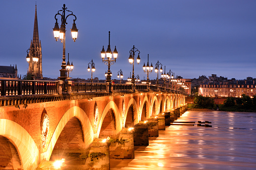 The Pont de pierre or Stone Bridge in Bordeaux at night, France