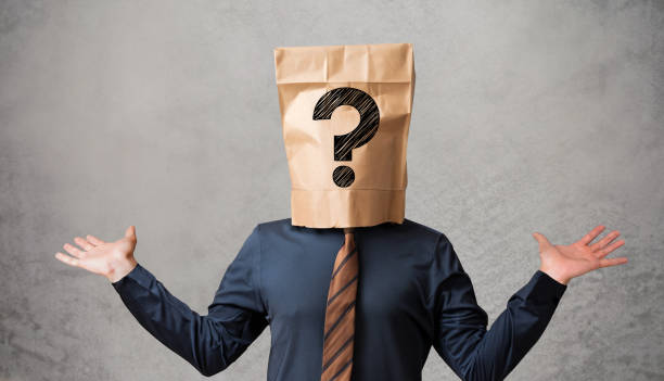 Businessman wearing paper bag on head with a question mark concept Businessman wearing paper bag on head with a question mark concept embarrassment unrecognizable person wearing a paper bag human head stock pictures, royalty-free photos & images