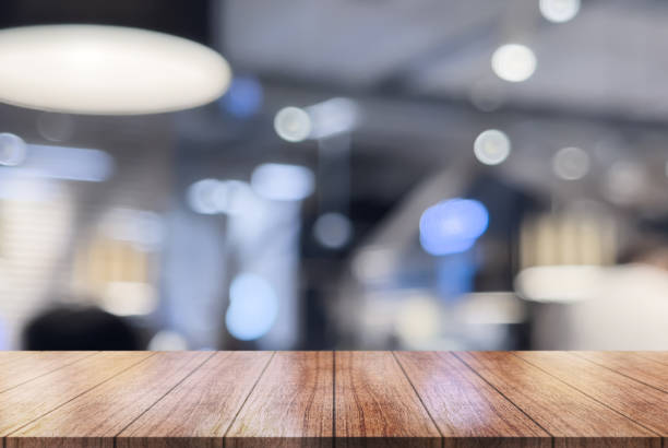 istock Empty wooden table top with lights bokeh on blur restaurant background. 1525268730